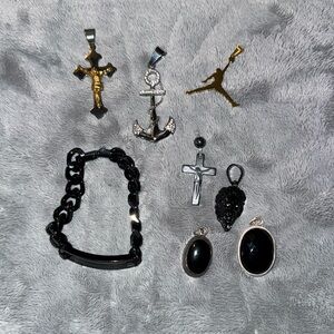#38 Assortment of metal pendants and one black wrist chain